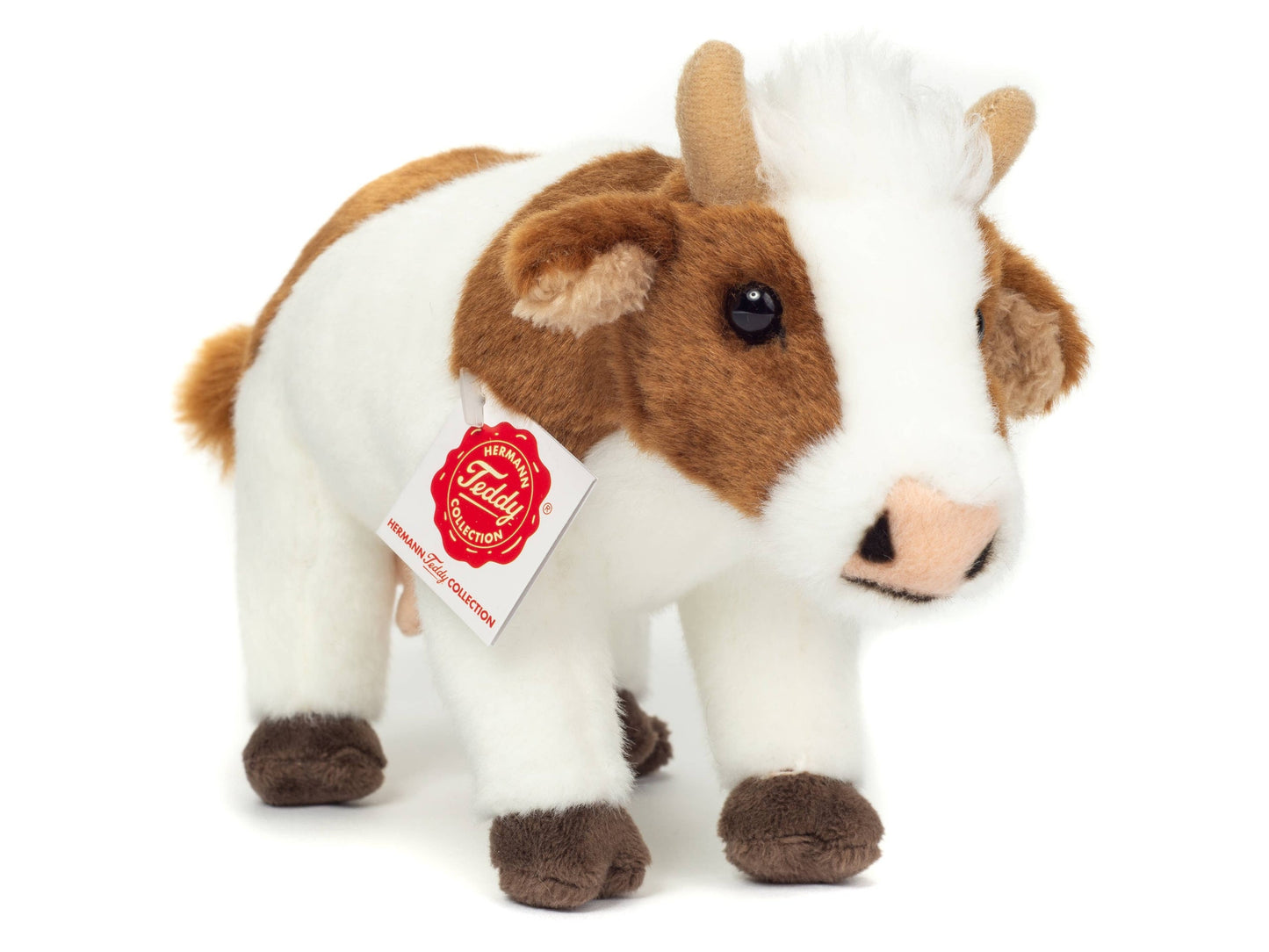 Brown and white cow plush toy